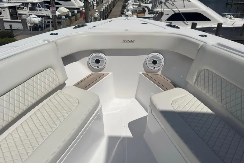 Slide: The Image of Luxurious seating area on a 2023 Jupiter 40 boat, featuring diamond-stitched upholstery. - 46