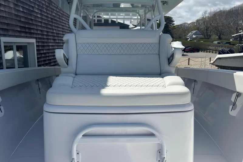 Slide: The Image of Luxury seating on a 2023 Jupiter 40 boat, featuring white cushioned upholstery. - 53