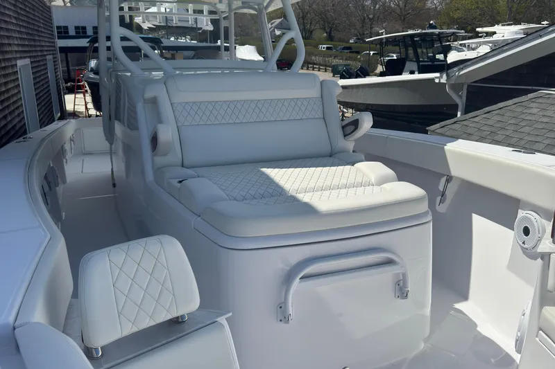 Slide: The Image of 2023 Jupiter 40 boat interior with white cushioned seating and sleek design. - 54