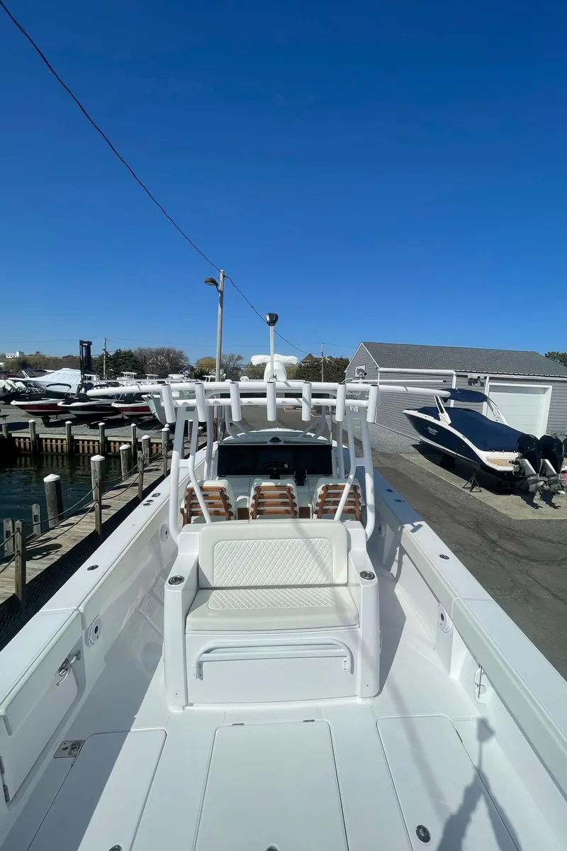 Slide: The Image of 2023 Jupiter 40 boat docked at a marina under a clear blue sky. - 7