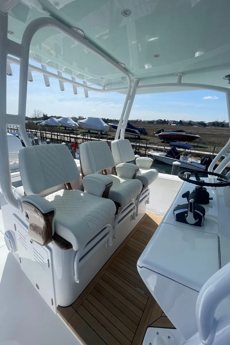 Slide: The Image of Luxurious seating area on a 2023 Jupiter 40 boat with a sleek design. - 9