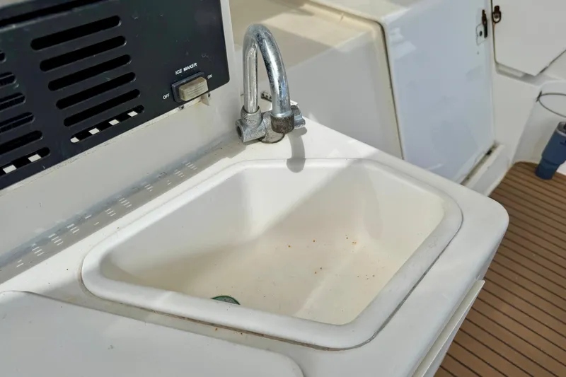 Slide: The Image of Sink and ice maker on 2000 Silverton 322 Motor Yacht deck. - 10