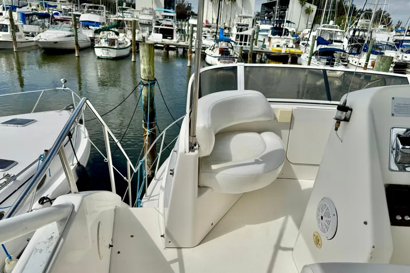 Slide: The Image of 2000 Silverton 322 Motor Yacht helm with marina view. - 11