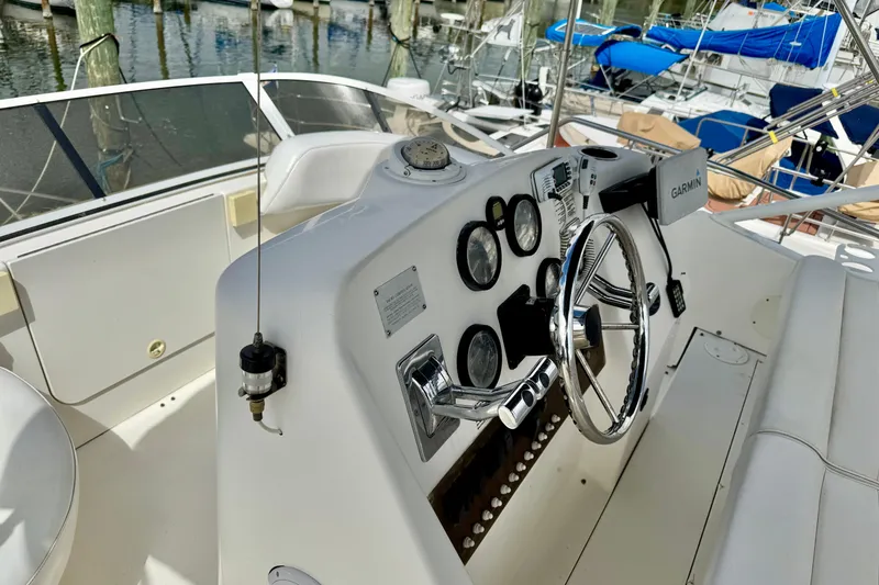 Slide: The Image of 2000 Silverton 322 Motor Yacht helm with steering wheel and navigation instruments. - 14