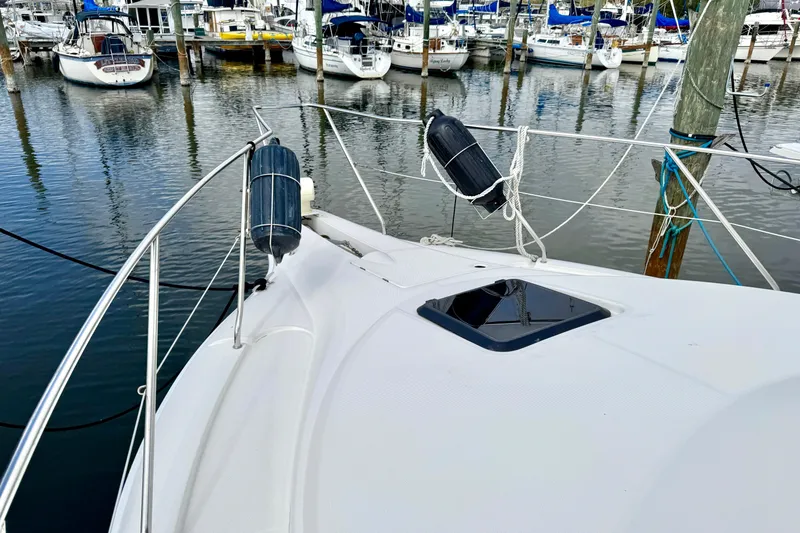 Slide: The Image of 2000 Silverton 322 Motor Yacht docked in a marina with other boats. - 19