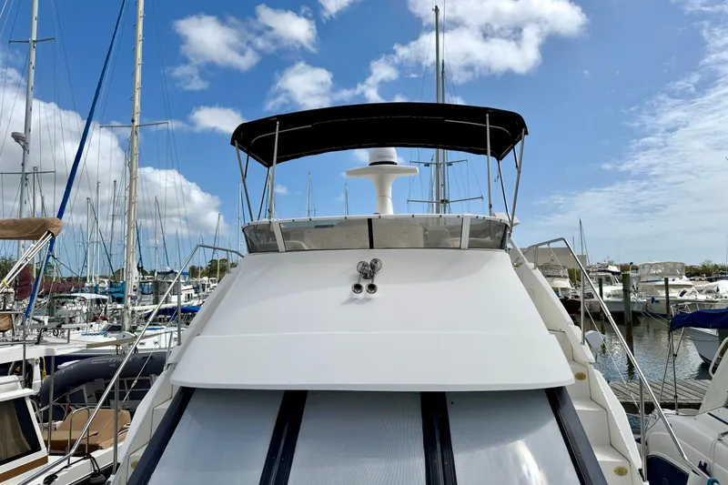 Slide: The Image of 2000 Silverton 322 Motor Yacht docked at marina under blue sky. - 22