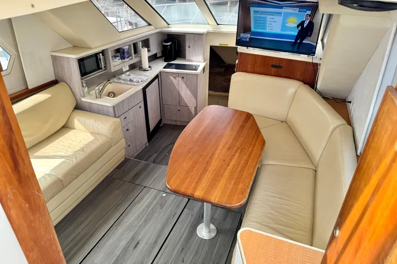 Slide: The Image of Interior of 2000 Silverton 322 Motor Yacht with seating, kitchenette, and TV. - 25