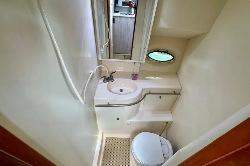 Slide: The Image of Bathroom interior of 2000 Silverton 322 Motor Yacht with sink and toilet. - 29