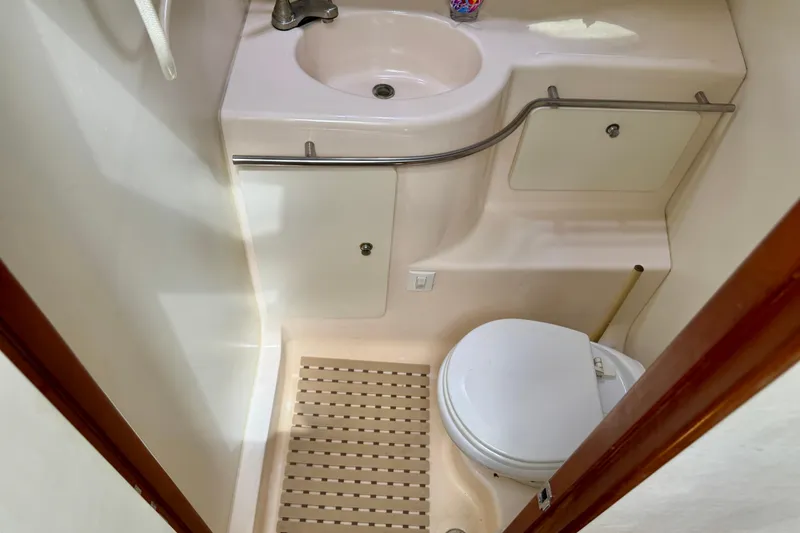 Slide: The Image of Bathroom interior of 2000 Silverton 322 Motor Yacht with sink and toilet. - 31