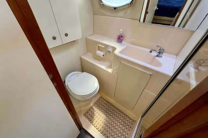 Slide: The Image of Bathroom interior of 2000 Silverton 322 Motor Yacht with sink and toilet. - 34