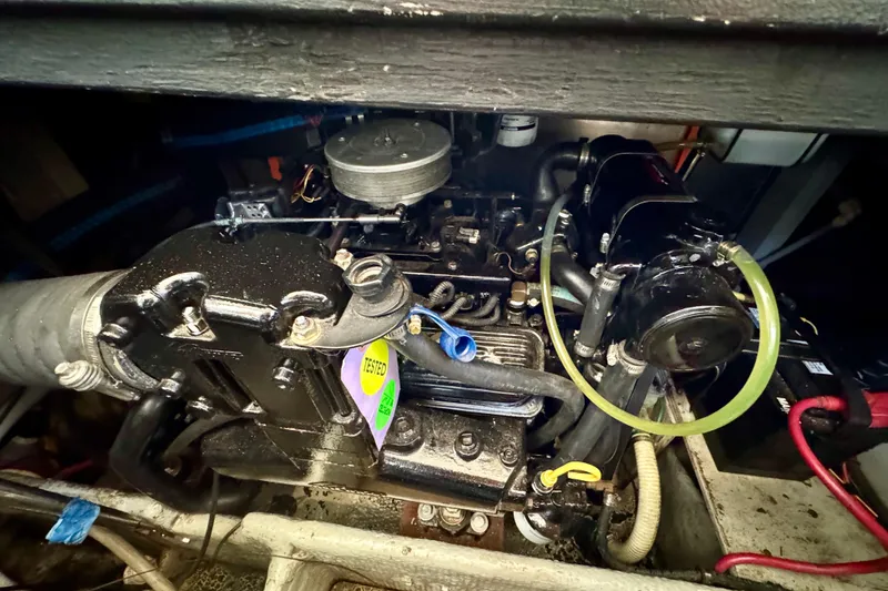 Slide: The Image of Engine compartment of a 2000 Silverton 322 Motor Yacht, showcasing mechanical components. - 35