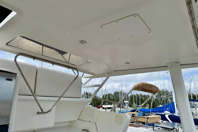 Slide: The Image of 2000 Silverton 322 Motor Yacht interior with seating and marina view. - 4