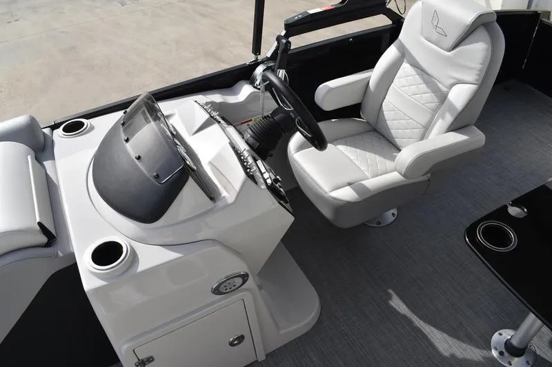 Slide: The Image of 2026 Lowe SS 210 boat interior with steering console and comfortable seating. - 11