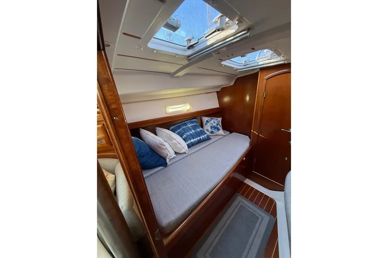 Slide: The Image of Cozy cabin interior of 2001 Beneteau 393 sailboat with skylight and cushions. - 12