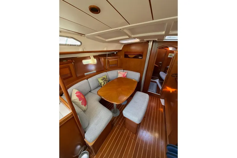 Slide: The Image of Interior of 2001 Beneteau 393 yacht with cozy seating and wooden table. - 14