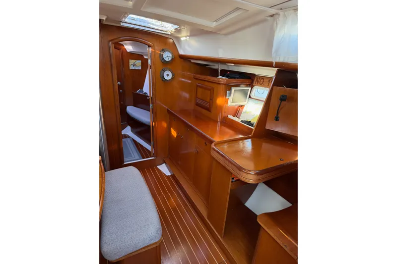 Slide: The Image of Interior of 2001 Beneteau 393 sailboat with wooden cabinetry and seating area. - 17