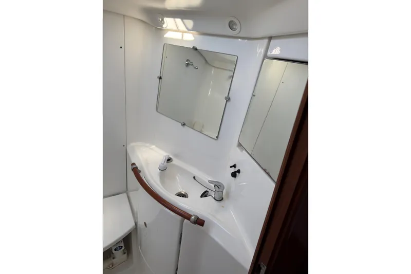 Slide: The Image of Bathroom interior of 2001 Beneteau 393 yacht, featuring sink and mirror. - 19