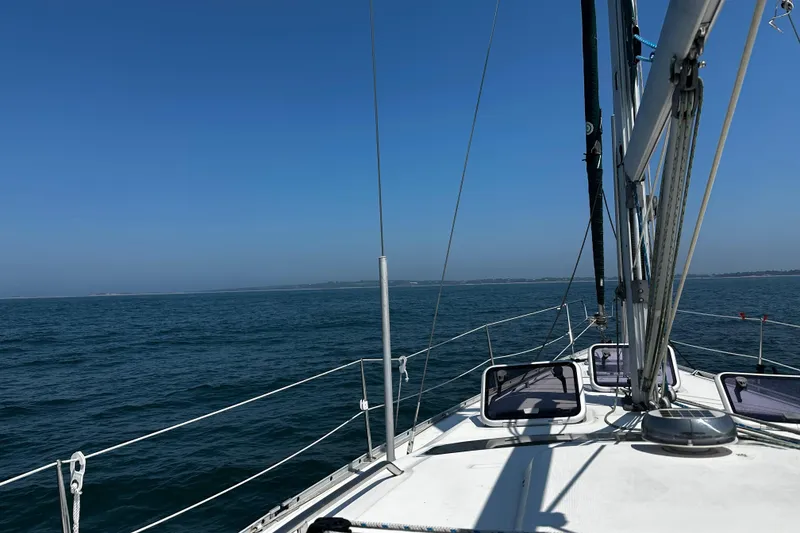 Slide: The Image of Sailing on a 2001 Beneteau 393 yacht under clear blue skies. - 4