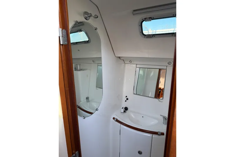 Slide: The Image of Bathroom interior of a 2001 Beneteau 393 yacht, featuring a sink and mirror. - 7