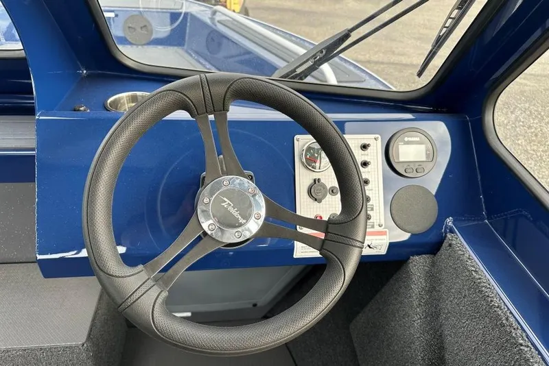 Slide: The Image of Steering wheel and dashboard of 2026 Weldcraft 200 Rebel boat, featuring modern controls. - 7