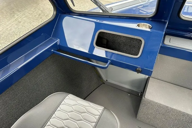Slide: The Image of Interior of 2026 Weldcraft 200 Rebel boat, featuring blue and gray seating. - 8