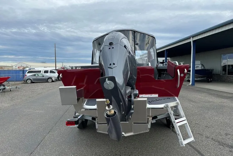 Slide: The Image of 2026 Weldcraft 210 Revolution boat with outboard motor, parked outdoors. - 4