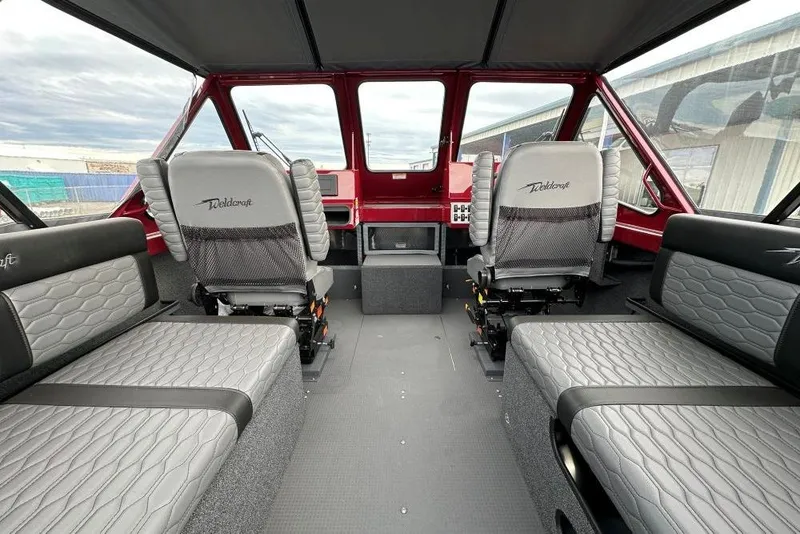 Slide: The Image of Interior of 2026 Weldcraft 210 Revolution boat with modern seating and dashboard. - 7