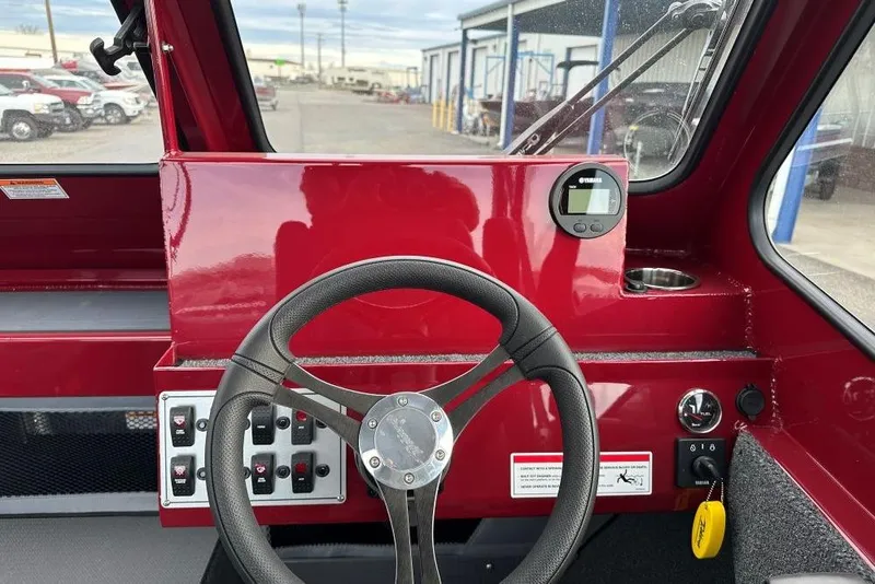 Slide: The Image of Interior view of 2026 Weldcraft 210 Revolution boat dashboard with steering wheel and controls. - 8