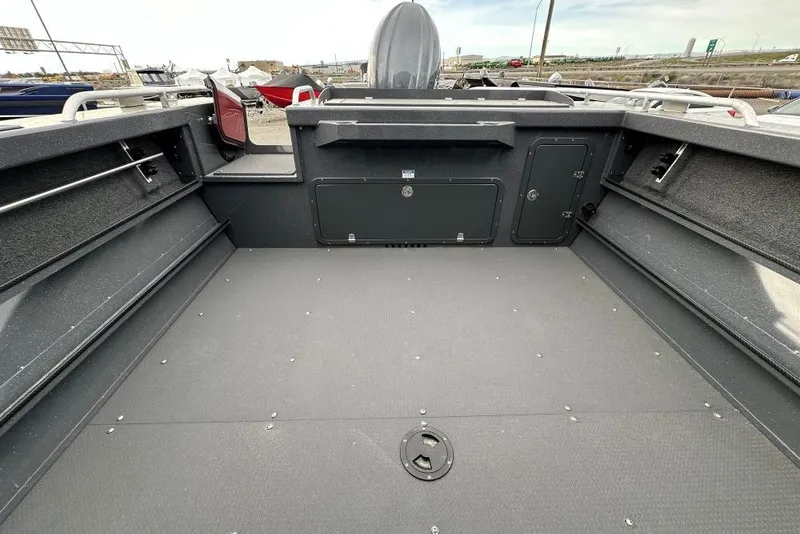 Slide: The Image of 2026 Weldcraft 210 Revolution boat interior with spacious deck and storage compartments. - 9