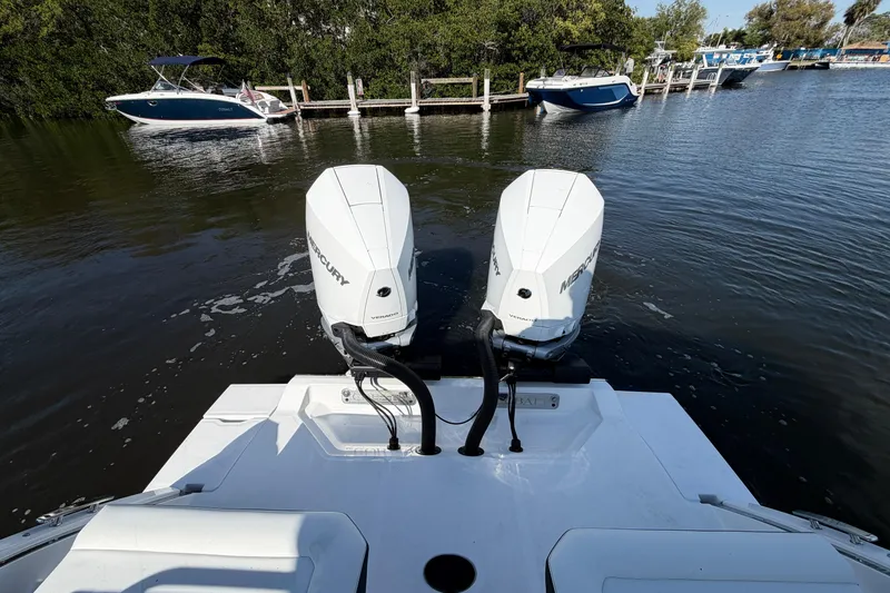 Slide: The Image of 2026 Cobalt R8 Outboard with dual Mercury engines on a calm waterway. - 12