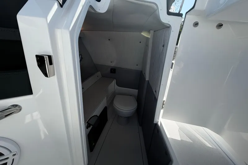 Slide: The Image of Interior of 2026 Cobalt R8 Outboard boat featuring a compact bathroom. - 15