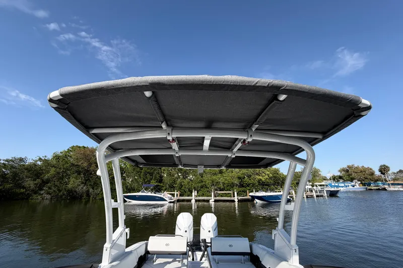 Slide: The Image of 2026 Cobalt R8 Outboard boat with canopy, docked on a sunny day. - 16