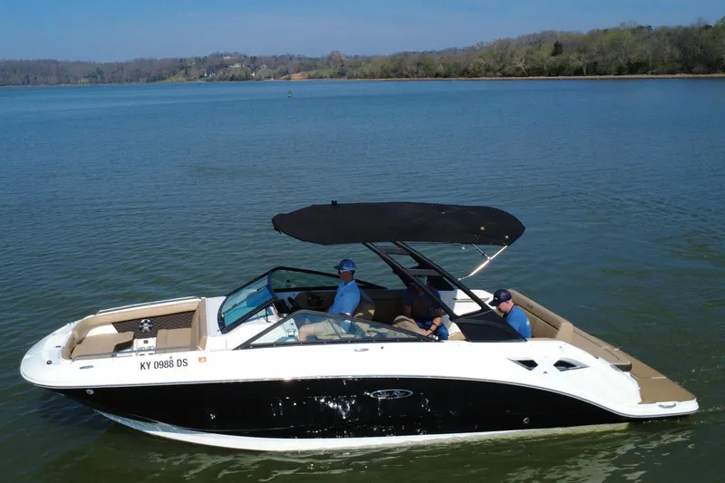 Slide: The Image of 2023 Sea Ray SDX 250 boat cruising on a calm lake with passengers onboard. - 15