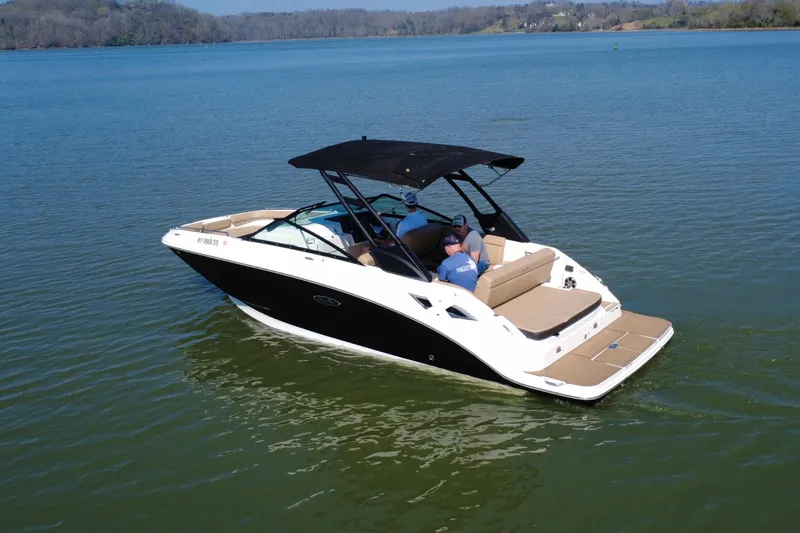 Slide: The Image of 2023 Sea Ray SDX 250 boat cruising on a serene lake with passengers onboard. - 20