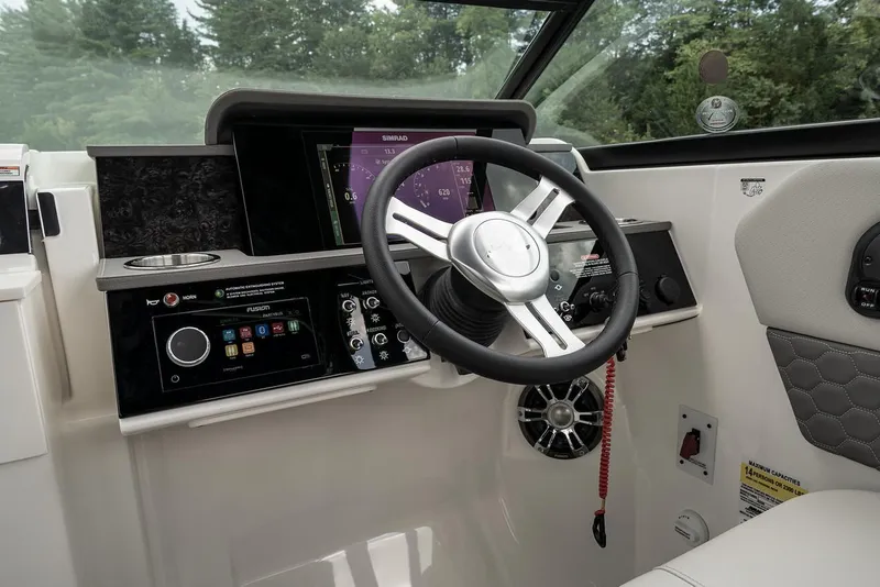 Slide: The Image of Manufacturer Provided Image: 2023 Sea Ray SDX 250 boat dashboard with steering wheel and control panel. - 9