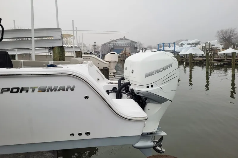 Slide: The Image of 2022 Sportsman Open 302 Center Console with Mercury outboard at a marina. - 3