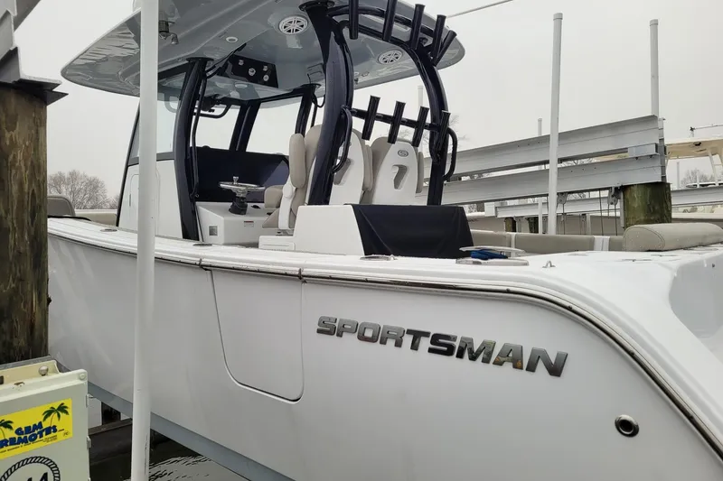 Slide: The Image of 2022 Sportsman Open 302 Center Console boat docked, showcasing sleek design and modern features. - 4