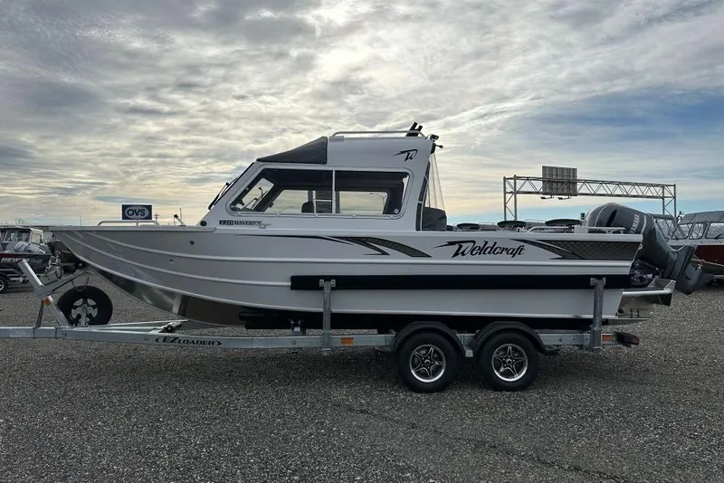 The Image of 2026 Weldcraft 220 Maverick boat on trailer under cloudy sky. - 1