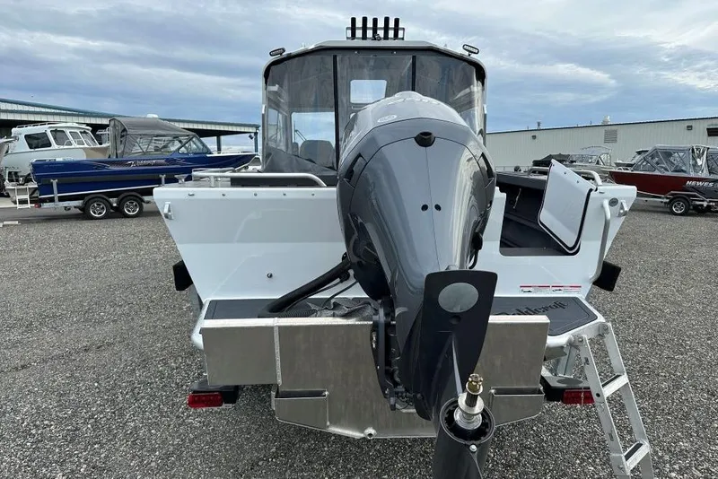 Slide: The Image of 2026 Weldcraft 220 Maverick boat with outboard motor, parked in a marina. - 4