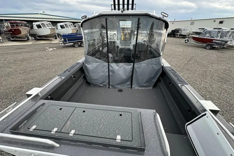 Slide: The Image of 2026 Weldcraft 220 Maverick boat with covered cabin, parked in a marina. - 5