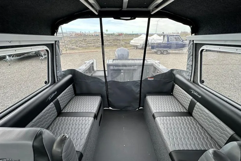 Slide: The Image of Interior of 2026 Weldcraft 220 Maverick boat with gray seating and panoramic windows. - 6