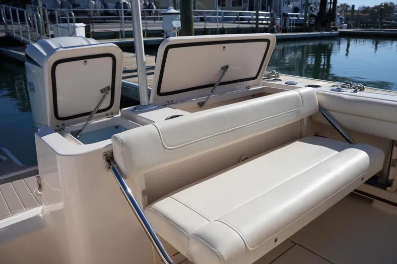 Slide: The Image of 2021 Grady-White Fisherman 236 boat interior with cushioned seating and storage compartments. - 13