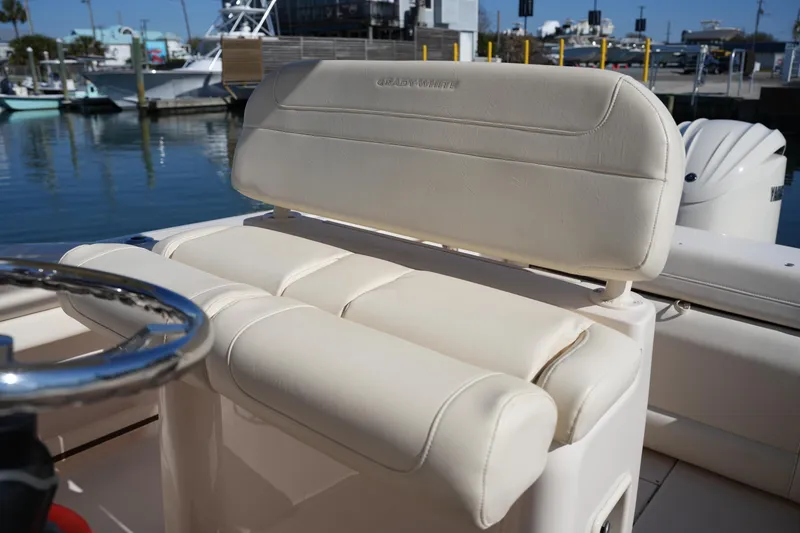 Slide: The Image of 2021 Grady-White Fisherman 236 boat seat with steering wheel, docked at marina. - 17