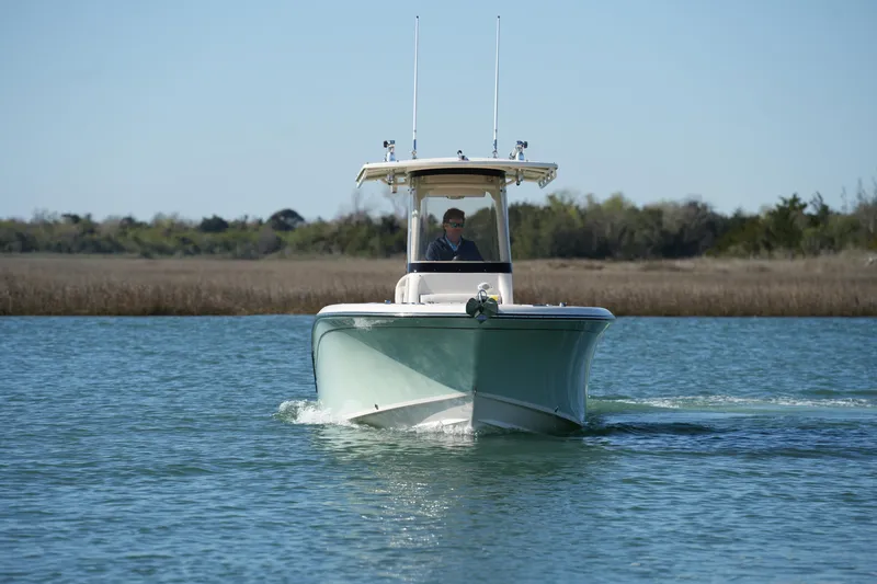 Slide: The Image of 2021 Grady-White Fisherman 236 boat cruising on a calm lake. - 2