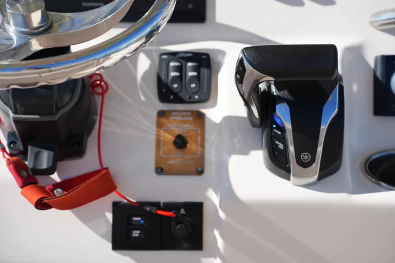 Slide: The Image of Control panel of 2021 Grady-White Fisherman 236 boat with steering wheel and throttle. - 22