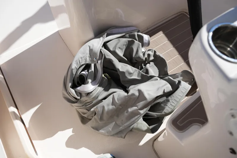 Slide: The Image of Gray jacket on deck of 2021 Grady-White Fisherman 236 boat. - 28