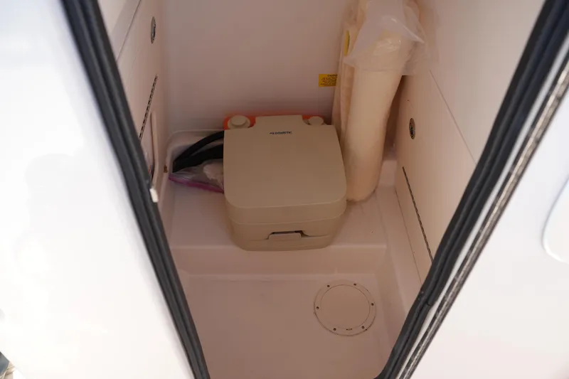 Slide: The Image of 2021 Grady-White Fisherman 236 boat interior with portable toilet and storage space. - 29