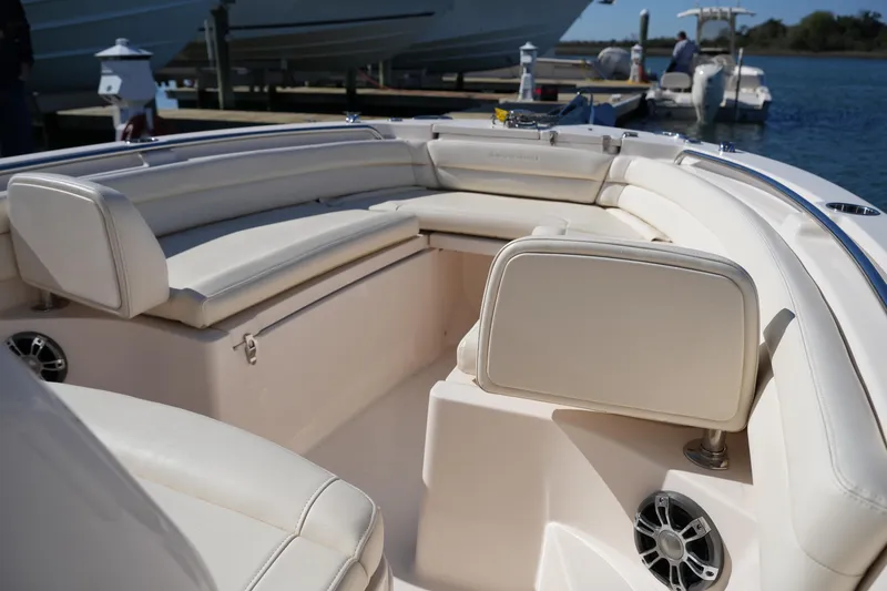 Slide: The Image of 2021 Grady-White Fisherman 236 boat interior with white seating and speakers. - 34