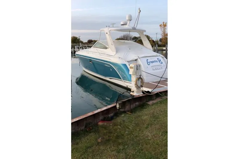 Slide: The Image of 2006 Formula 40 Performance Cruiser docked, featuring sleek design and blue hull. - 3