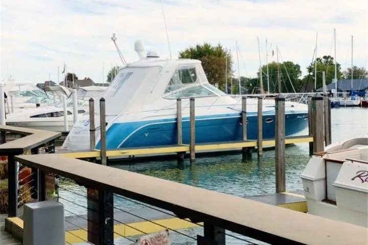 Slide: The Image of 2006 Formula 40 Performance Cruiser docked at a marina, featuring a sleek blue and white design. - 4